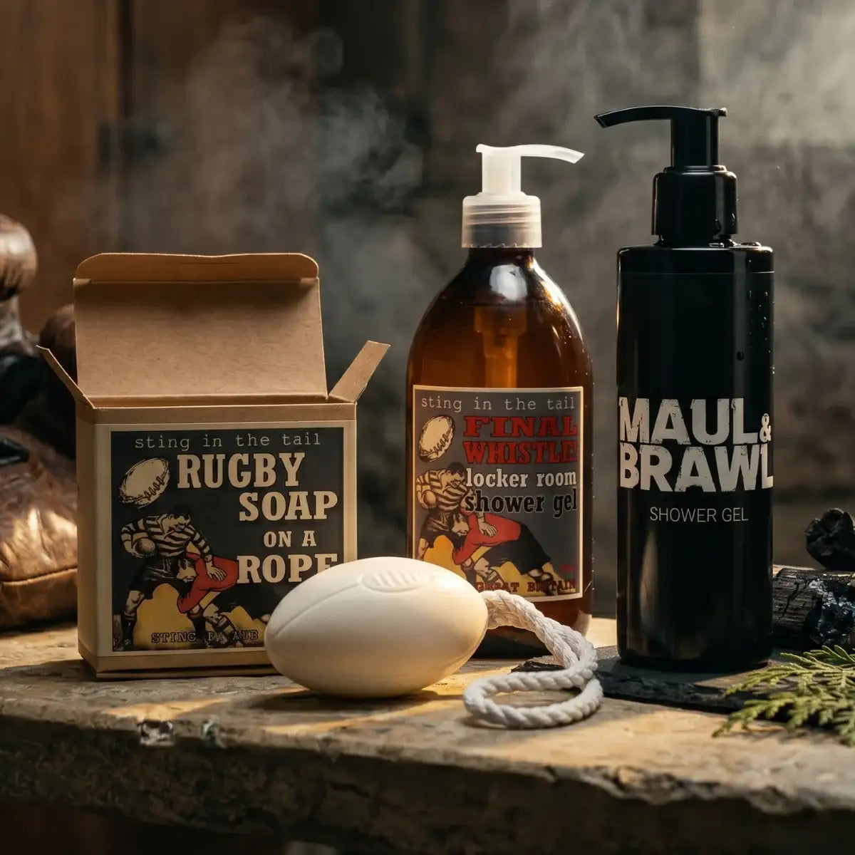 Collection of grooming products including a box labeled 'Rugby Soap on a Rope', bottles, and a soap on a rope.