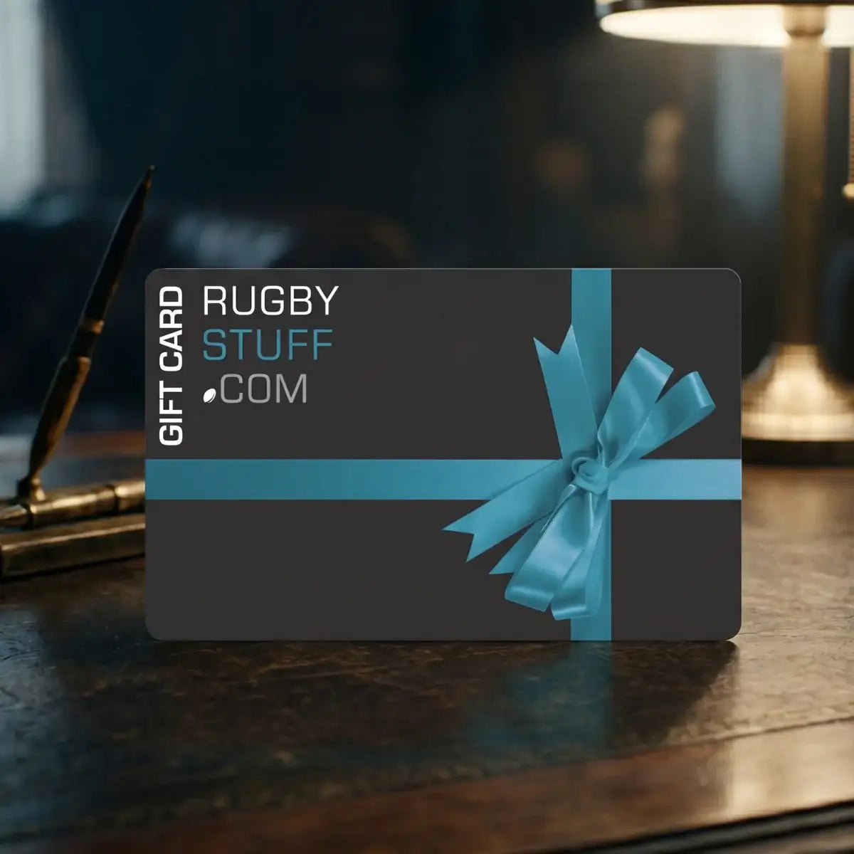Gift card with blue ribbon on a dark surface, featuring 'Rugby Stuff' branding.